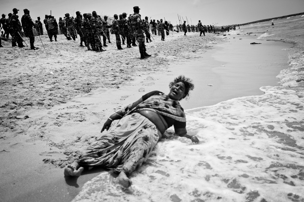 Xavieramma, a resident of Idinthakarai, cries out for help after being chased into the sea with no place to run. She was later helped out and arrested by the security forces. She has been charged with 16 cases including serious charges like sedition and waging war against the nation.