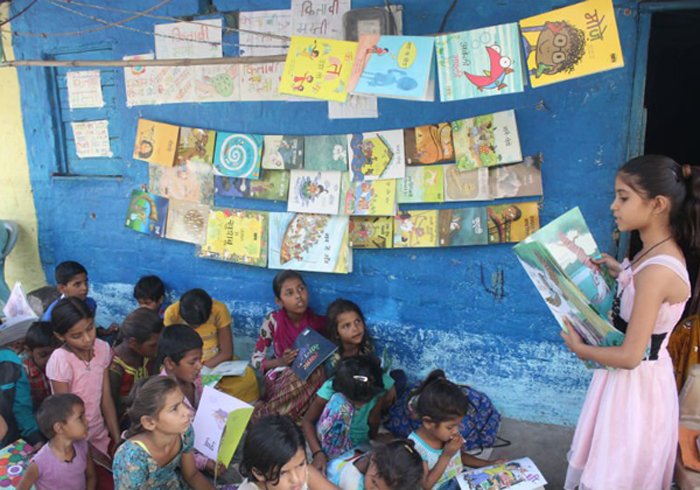 A Girl Who Has Set Up A Library Outside Her House For The Slum Children In Her Neighborhood