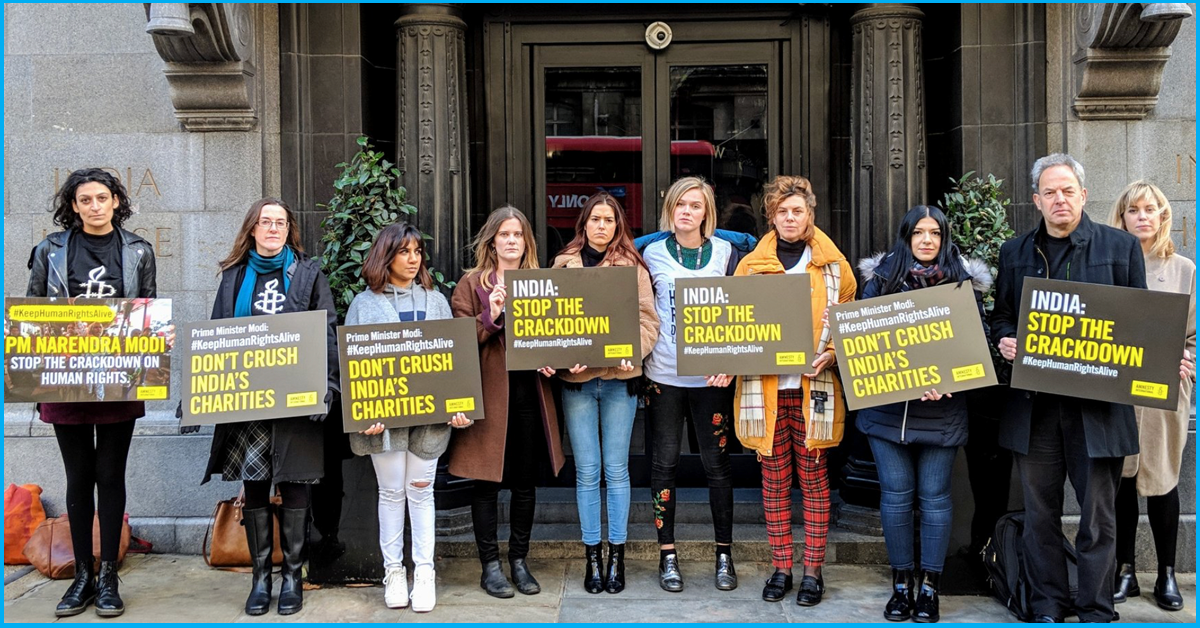 UK: Amnesty Int. Stages Protest Against Modi Govt’s Clampdown On International NGOs