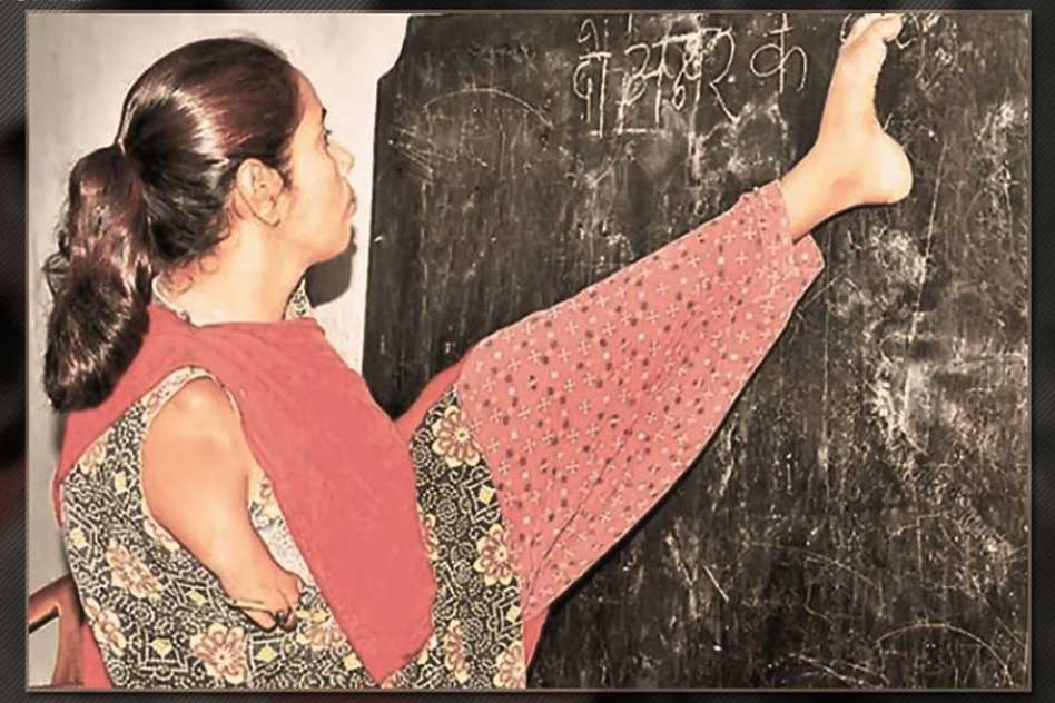 She Writes On The Blackboard And Checks Copies Of Her Students Using Her Feet