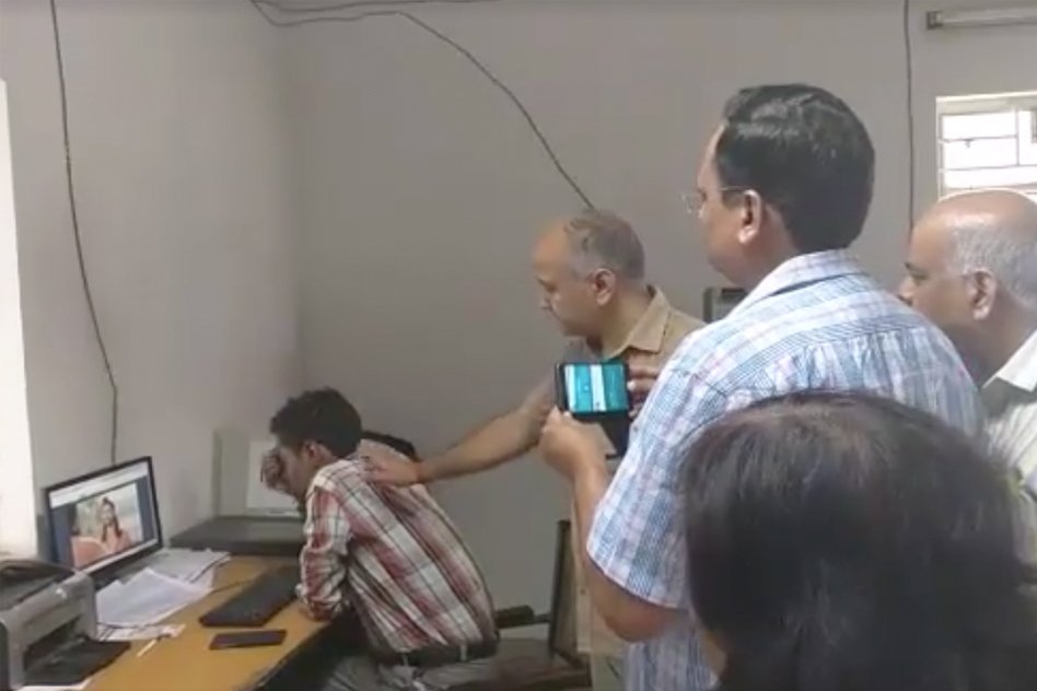 [Watch] Deputy CM Of Delhi Caught A Hospital Staff Watching Movie, While Patients Wait Outside