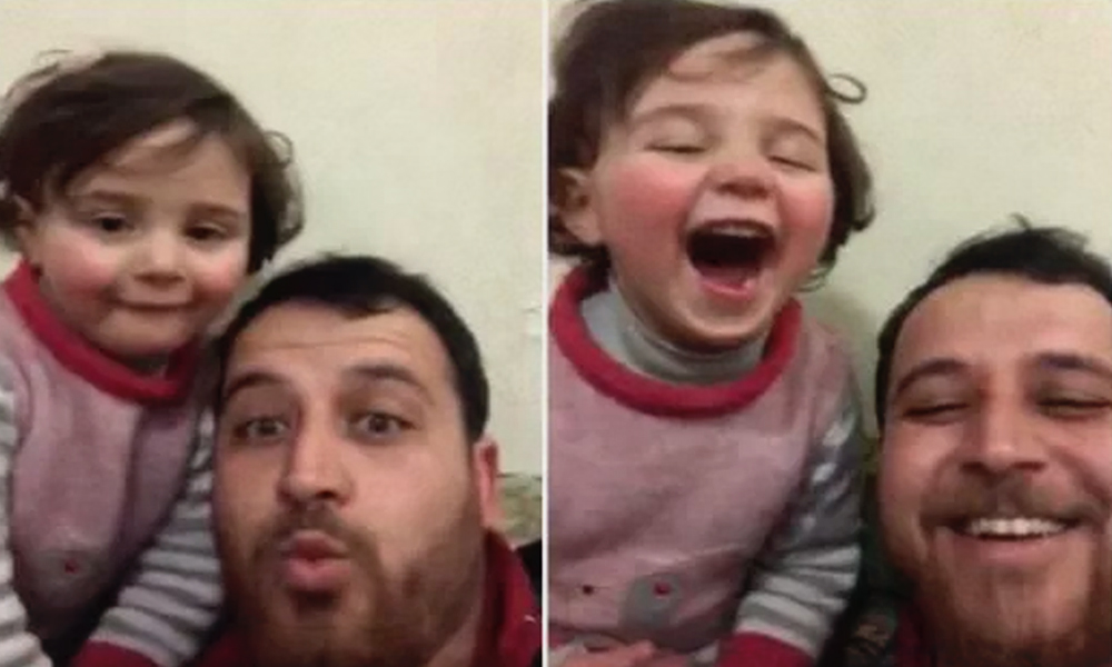 Watch| Syrian Dad Teaches Daughter To Laugh As Bomb Drops, To Keep Her From Getting Scared