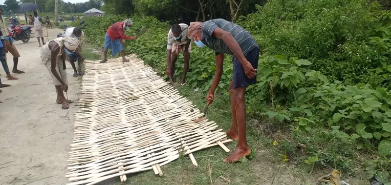 Locals use bamboo to make bridge in a flood-affected region