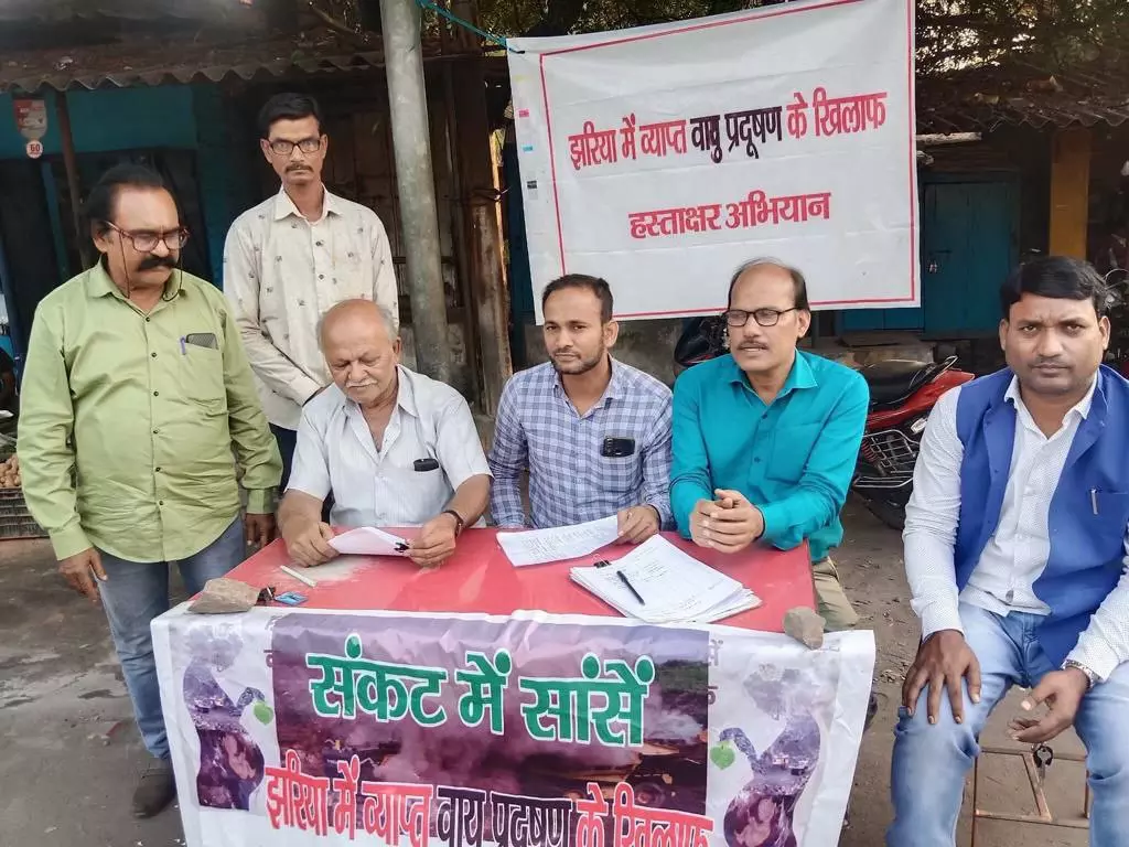 Activist Dilip Chakraborty advocating for the cause of pollution in Jharia through his signature campaign ( seated extreme left)