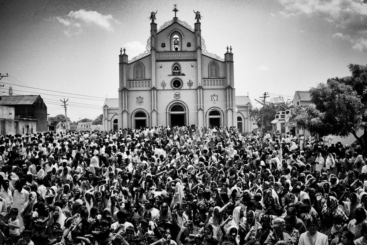 Villagers from the Koothankuli, prevented from going to Idinthakarai by the imposition of a curfew, gather in front of the church and shout anti-government slogans.