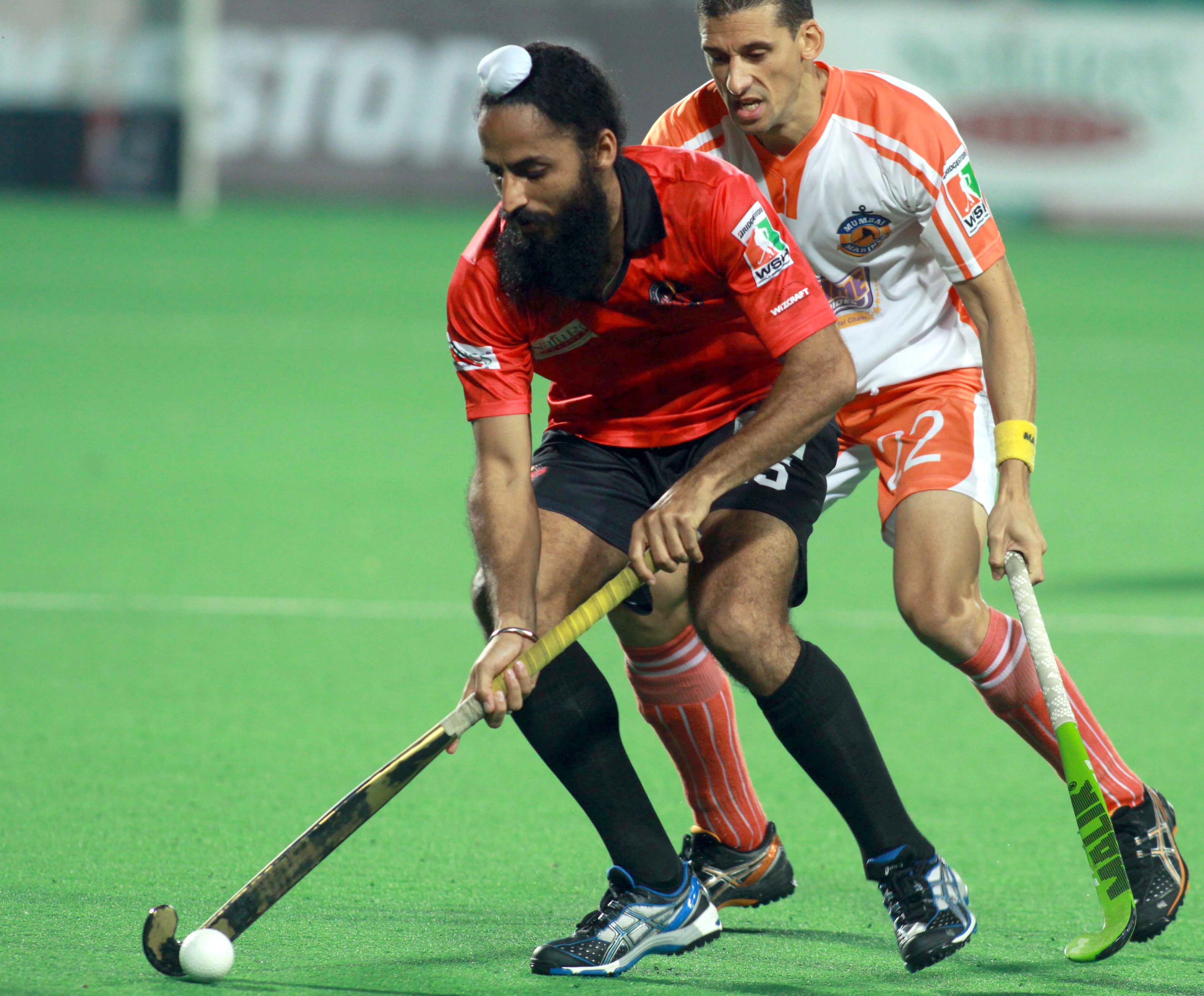 Bridgestone World Series Hockey 2012: Rajpal Singh(L) from Delhi Wizards & Clyde Abrahams(R) from Mumbai Marines team in action during their match at Delhi on 19th March 2012.
