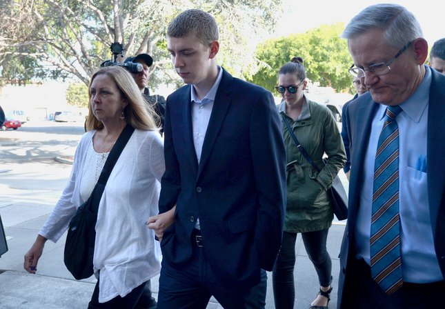 Brock Turner, 20, center, makes his way into the Santa Clara Superior Courthouse in Palo Alto, Calif., on Thursday, June 2, 2016. Brock, a former Stanford swimmer, was convicted of 3 counts of felony sexual assault on a 22-year-old young woman on the Stanford campus following a party on January 18, 2015. Brock was in court for his sentencing. (Dan Honda/Bay Area News Group)